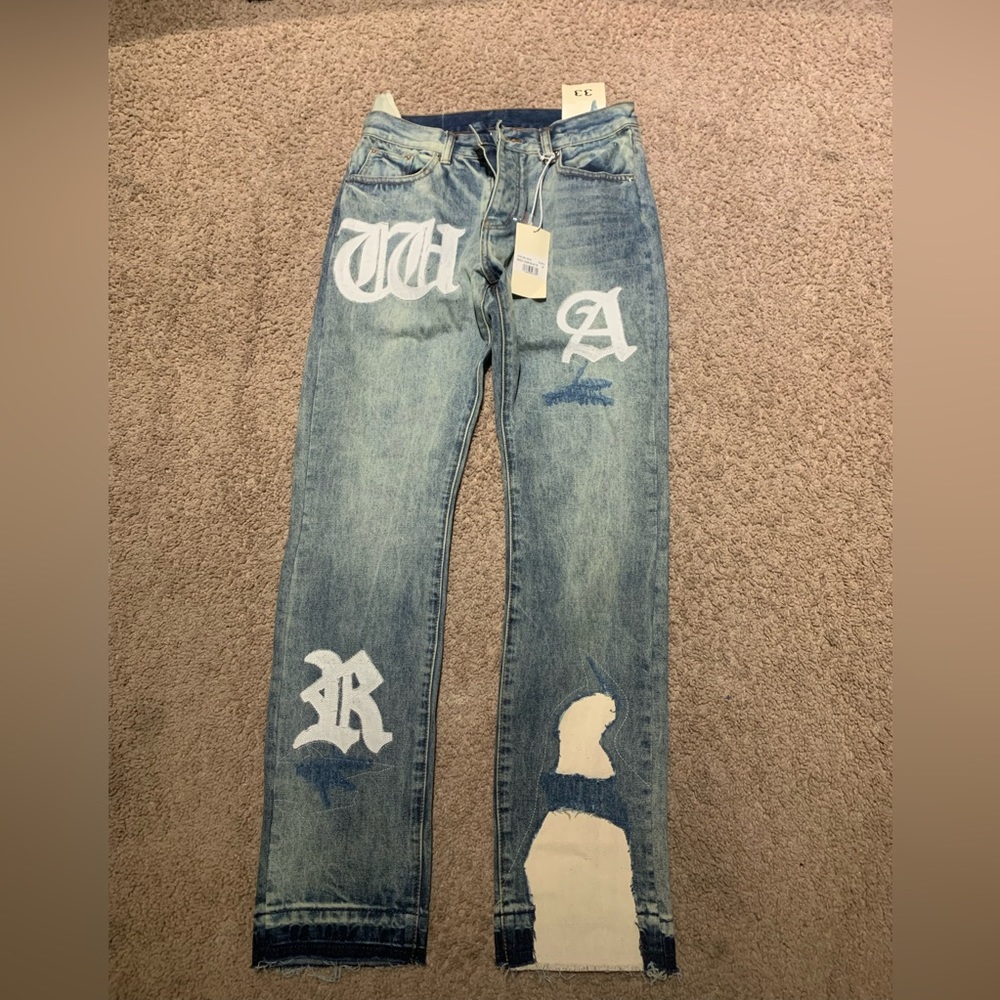 straight denim MNML jeans that have the word war written on it.